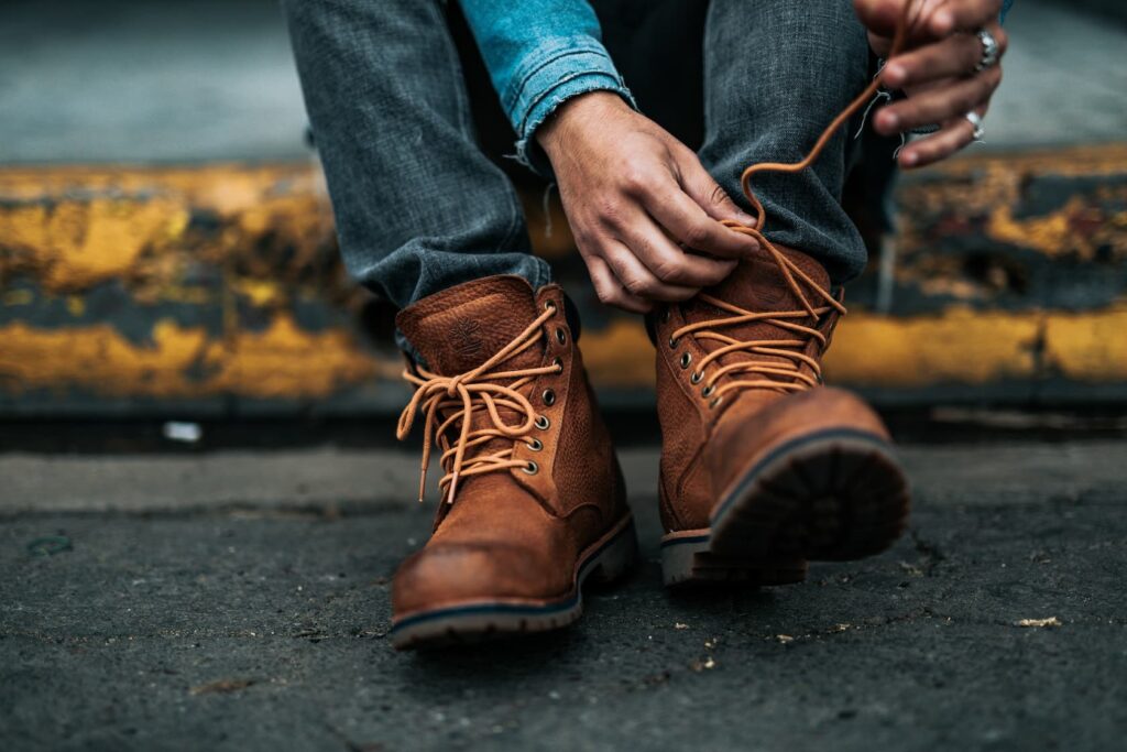 An image of someone lacing up their work boots